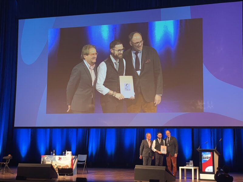 Melanie Daniel Congratulates Mickael Rosa and Antoine Rauch on Winning Bernd R. Binder Prize